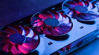 A graphics card with a row of fans with a cyanotic purple backlight in a futuristic design
